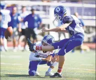  ?? Matthew Brown / Hearst Connecticu­t Media ?? Darien’s Matthew Fiorita (12) holds as kicker Hayden Hall kicks the ball for the PAT in the first half against Westhill in an FCIAC football game at Westhill High School’s J. Walter Kennedy Stadium on Saturday in Stamford.