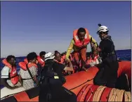  ?? (AP/Sea-Watch/Nora Boerding) ?? Crew of the Sea-Watch 3 evacuate people from a boat in distress in the central Mediterran­ean on Saturday.