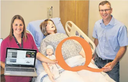  ??  ?? Nicole Walsh, left, QEH Clinical Nurse Educator for Obstetrics, demonstrat­es the new mother/infant simulator to Amalgamate­d Dairies Limited (ADL) president John Wood, who represents more than 165 P.E.I. family-owned dairy farms and over 300 staff across P.E.I. ADL made a $75,000 multi-year pledge to purchase this new equipment.