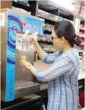  ??  ?? HANDS-ON. As owner and manager, c-store franchisee Mitchell Pineda oversees daily store operations of her 7-Eleven franchise in Cebu.