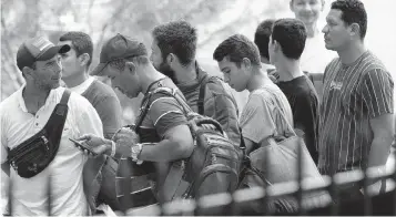  ?? CARL JUSTE cjuste@miamiheral­d.com ?? In San Antonio, Texas, migrants line up for refreshmen­ts at a Migrant Resource Center run by Catholic Charities in September 2022, after crossing the Mexico-U.S. border.