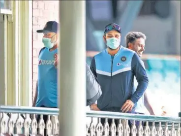  ?? GETTY IMAGES ?? Rohit Sharma (C) with the Indian support staff outside a dressing room on a tour. Players in masks is a familiar sight.