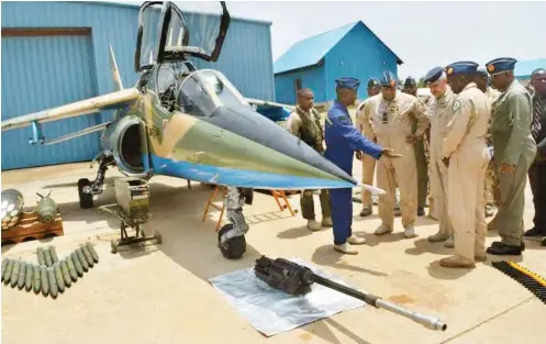  ??  ?? The visiting Commander, Royal Jordanian Air Force Maj.-Gen. Yousef Al-Hnaity (3rd right) inspects some ammunition and bombs at an Air force base in the North-East in preparatio­n for his country’s military aid to boost the war against Boko Haram insurgent