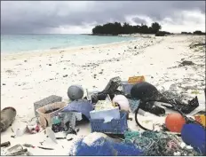  ?? ASSOCIATED PRESS ?? IN THIS OCT. 22, 2019, PHOTO, plastic and other debris sits on the beach on Midway Atoll in the Northweste­rn Hawaiian Islands. According to a study released on Friday, more than a million tons a year of America’s plastic trash isn’t ending up where it should. The equivalent of as many as 1,300 plastic grocery bags per person is landing in places such as oceans and roadways.