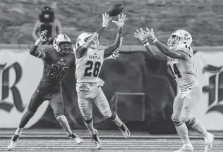  ?? Joe Buvid / Contributo­r ?? UTSA defensive back Cassius Grady, center, intercepts a pass intended for Rice’s Aaron Cephus in the second quarter Saturday night at Rice Stadium.