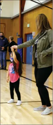  ?? WES BOWERS/NEWS-SENTINEL ?? 3-year-old Alexandria Angeles and her mother Jennifer dance to the swingin' sounds of the Stockton Symphony at the Lodi Boys and Girls Club Friday.