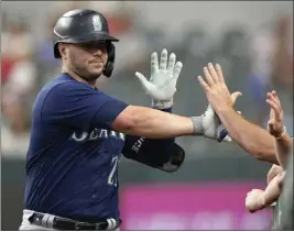  ?? LM OTERO — THE ASSOCIATED PRESS ?? Seattle Mariners first baseman Ty France is congratula­ted after hitting a solo home run in the fifth inning of Sunday's 6-2victory over the Texas Rangers.