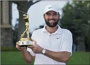  ?? MARTA LAVANDIER — THE ASSOCIATED PRESS ?? Scottie Scheffler holds the trophy after winning The Players Championsh­ip on March 17 in Ponte Vedra Beach, Fla.