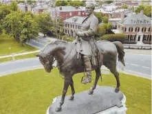  ?? AP PHOTO ?? MOVE IT: Statues like this one of Robert E. Lee in Richmond, Va., inspire reverence for Confederat­e ideals.