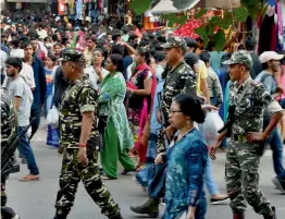  ?? — PTI ?? Security personnel patrol a crowded market ahead of Diwali in New Delhi on Sunday.