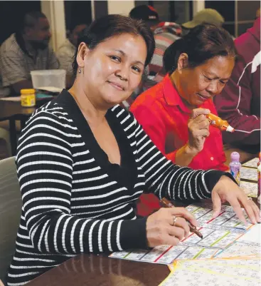  ?? Picture: STEWART McLEAN ?? HEADS UP: Julie Welsh plays bingo at the Cairns Brass Hall. She looks forward to Thursdays as her day to relax with friends.