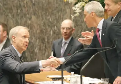  ??  ?? Gov. Bruce Rauner ( left) shakes the hand of Mayor Rahm Emanuel at a City Council meeting in 2015. While once friendly, the two have been feuding for some time about Chicago’s school funding crisis — and how to fix it.| AP FILE PHOTO