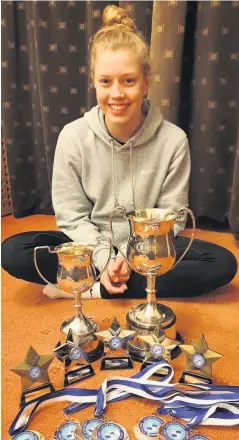  ??  ?? ■ Abbie Ruddle pictured with her championsh­ip medals.