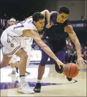  ?? BEN MARGOT — ASSOCIATED PRESS ?? Saint Mary’s Evan Fitzner, left, and Cal State Fullerton’s Jackson Rowe chase a loose ball during the first half.