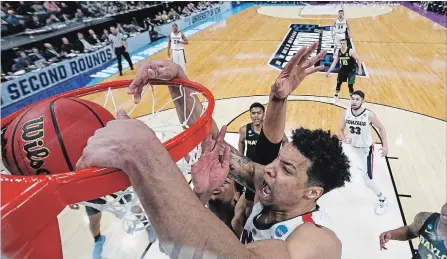  ?? PATRICK SMITH GETTY IMAGES ?? Gonzaga’s Brandon Clarke scores two of his 36 points, including five massive dunks, against the Baylor Bears during their second-round game in the NCAA basketball tournament at Vivint Smart Home Arena in Salt Lake City, Utah, on Saturday. Gonzaga won, 83-71.