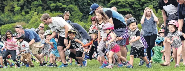  ?? PHOTOS: PETER MCINTOSH ?? And they’re off . . . A gaggle of 3yearolds set off, urged on by proud parents, during the annual Stride, Ride and Slide minitriath­lon at Dunedin’s Logan Park yesterday.