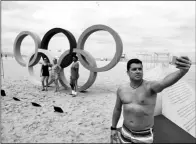  ?? STOYAN NENOV / REUTERS ?? A man takes a selfie in front of the Olympic Rings, displayed at Copacabana beach ahead of the 2016 Olympic Games in Rio de Janeiro on July 22.