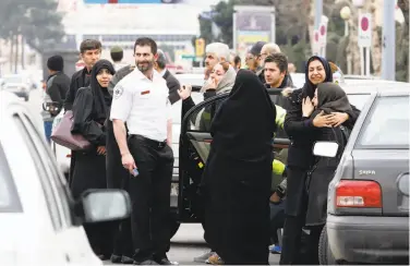  ?? Atta Kenare / AFP / Getty Images ?? Relatives of passengers on the plane that crashed gather near Tehran Mehrabad Internatio­nal Airport.