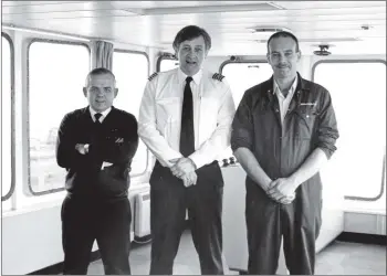  ?? 01_B46twe03 ?? Second mate Andy Keen, captain Ian Walker and lookout Colin Campbell are pictured on the bridge of the MV Caledonian Isles last week in force eight gales.