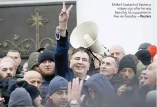  ?? — Reuters ?? Mikheil Saakashvil­i flashes a victory sign after he was freed by his supporters in Kiev on Tuesday.