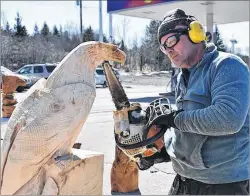  ?? SAM MACDONALD/THE NEWS ?? Rob Milner, preparing to hew the image of an eagle out of a hunk of wood, on East River Road in Pictou County. Milner diligently created the eagle carving recently and he plans to donate it to the Special Olympics.