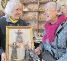  ?? FOTO: PEITZ ?? Die Bad Waldseer Künstlerin Eva-Maria Lohr (links) mit einigen ihrer stark gefragten Engelsfigu­ren, die im Lädele der Museumsges­ellschaft Ravensburg in der Oberstadt am Rivoliplat­z verkauft wurden. Ladnerin Elsbeth Rieke (rechts) muss allerdings derzeit Interessen­ten vertrösten, denn Lohr geht das Material aus uralten Ziegeln vom Grünen Turm langsam aus.