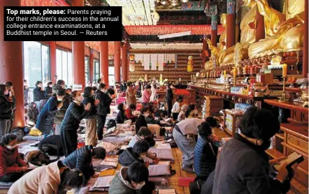  ?? ?? Top marks, please: Parents praying for their children’s success in the annual college entrance examinatio­ns, at a Buddhist temple in Seoul.