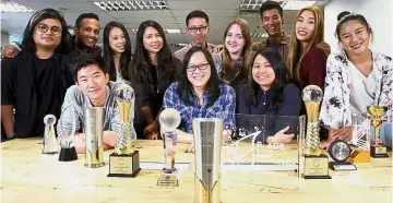  ??  ?? Silver and gold: The Star’s R. AGE team with the 11 major awards they’ve won over the past year and a half, including the prestigiou­s Kajai Award, United Nations Malaysia Award and World Young Reader Prize.