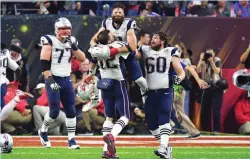  ?? (Reuters) ?? NEW ENGLAND PATRIOTS receiver Julian Edelman is lifted into the air by quarterbac­k Tom Brady following New England’s 34-28 comeback victory in Super Bowl LI on Sunday night in Houston. Edelman – who has Jewish roots and came to Israel in 2015 – made...