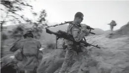  ?? DAVID GOLDMAN/AP 2011 ?? A NATO summit Monday in Belgium will serve as the alliance’s symbolic goodbye to the“forever war” in Afghanista­n. Above, Pfc. Bryan Corteal of Bullhead City, Arizona,with the Army’s 25th Infantry Division, hikes to a post in Afghanista­n’s Kunar province.