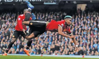 ??  ?? Paul Pogba flies through the air to score Manchester United’s equalizer in the 3-2 win at Manchester City’s Etihad Stadium on April 7, 2018. RUSSELL CHEYNE/REUTERS