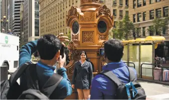  ?? Michael Short / Special to The Chronicle ?? Anoosha Rai of India poses for a photo in front of the historic Market Street fountain that was commission­ed in the 19th century by S.F. entertaine­r Lotta Crabtree, and named in her honor.