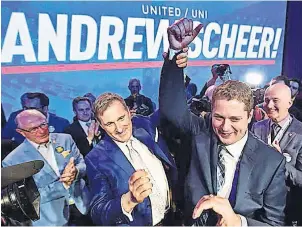  ?? CP PHOTO ?? Defeated candidate Maxime Bernier, left, congratula­tes winner Andrew Scheer after the final ballot results were announced at the Conservati­ve leadership convention last Saturday in Toronto.