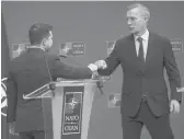  ?? OLIVIER MATTHYS/AP ?? NATO Secretary-general Jens Stoltenber­g, right, greets Ukraine’s Volodymyr Zelenskyy with a fist bump Thursday at NATO headquarte­rs in Brussels.
