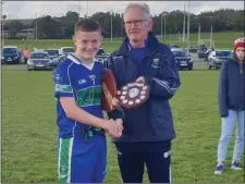  ??  ?? AGB captain Jack Mullen accepts the trophy from Owen Doyle.