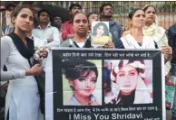  ?? RAFIQ MAQBOOL / ASSOCIATED PRESS ?? Fans of Bollywood actress Sridevi hold posters as they wait outside her residence to pay their last respects in Mumbai, India, on Wednesday.