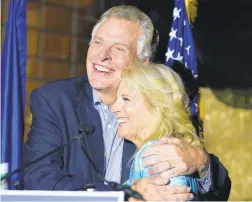  ?? STEVE HELBER/AP ?? First lady Jill Biden, right, gets a hug from Democratic gubernator­ial candidate Terry McAuliffe during a rally in Richmond on Friday. McAuliffe will face Republican Glenn Youngkin in the November election.