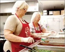  ?? LYNN KUTTER ENTERPRISE-LEADER ?? Connie Thomas, left, and Ruth Duncan with Farmington Senior Activity & Wellness Center put together meals for homebound senior adults who receive Meals on Wheels. This day, meals included meatloaf, potatoes and gravy, peas and carrots, wheat roll and...