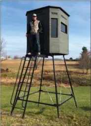  ?? TOM TATUM - FOR DFM ?? Thunder Ridge bow technician Caleb Stoltzfus with one of the shop’s elevated tree stands.