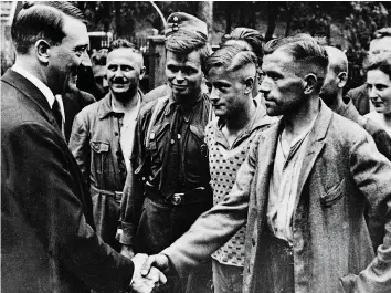  ?? ?? Manipulati­ng minds Adolf Hitler meets German workers in 1934. In the depressed interwar years, his regime encouraged ordinary Germans to view Jews as the cause of a host of problems afflicting their nation