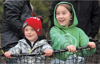  ?? ?? Carson Evans, 7, and Stella Burrell, 8, play inside a giant fishing net next to the canal below the Peterborou­gh Lift Lock.