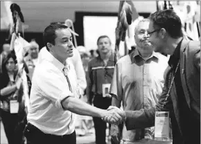  ?? — Photos by The Canadian Press ?? Newly re-elected Shawn Atleo shakes hands with attendees as national chief of the Assembly of First Nations to mark the end of the Annual General Assembly Toronto on Thursday.