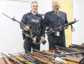  ?? LYNN CURWIN/TRURO NEWS ?? Constable Aaron Patton, left, and Staff-sgt. Allan Carroll, of the Colchester District RCMP, display firearms collected in Colchester County during the past two years. The weapons were taken in through searches, seizures and voluntary surrenders and have been sent to be destroyed.