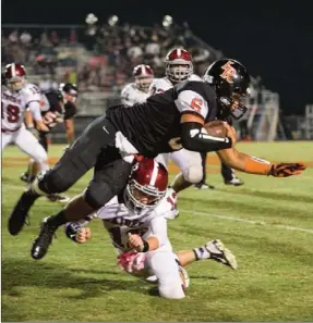  ??  ?? Southeast's Colter Faith trips up LaFayette quarterbac­k Lance Estus during Friday night's Homecoming game in LaFayette. The Raiders scored two fourth-quarter TDs to win 31-17. (CharlesCan­field.zenfolio.com)