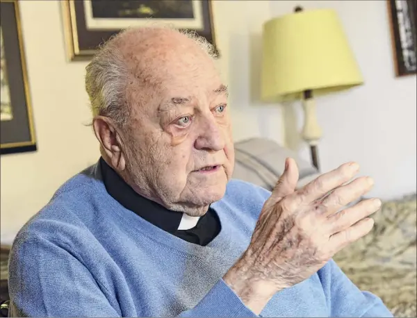  ?? Lori Van Buren / Times Union ?? Father Peter Young, 90, talks with a visitor at his home on Tuesday in Albany.