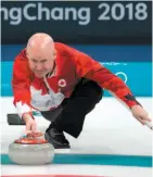  ?? CP PHOTO ?? Canada skip Kevin Koe throws a stone during a game against Italy at the Winter Olympics on Wednesday.