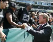  ?? TONY AVELAR — THE ASSOCIATED PRESS FILE ?? In this file photo, NFL broadcaste­r and former Oakland Raiders head coach Jon Gruden greets fans before an NFL preseason football game between the Raiders and the Dallas Cowboys in Oakland The Oakland Raiders are set to bring Jon Gruden back for a...