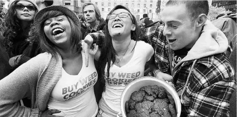  ?? Mark van Manen / Postmedia News ?? People shows off their weed cookies at a 4/20 celebratio­n in Vancouver in 2011.