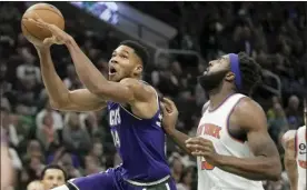  ?? AP photo ?? The Bucks’ Giannis Antetokoun­mpo shoots past the Knicks’ Mitchell Robinson during the second half Friday.