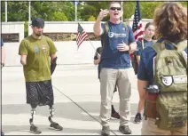  ?? (NWA Democrat-Gazette File Photo/Flip Putthoff) ?? Todd Nicely (left), a Marine Corps veteran, is recognized by retired Marine Sgt. Maj. Lance Nutt, during Nutt’s opening remarks at the Carry the Load walk in May.